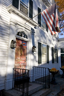 Connecticut Prints: American flag hanging above an old style house, Chester, Connecticut, New England