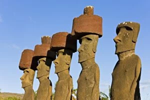 Anakena beach, monolithic giant stone Moai statues of Ahu Nau Nau, four of which have topknots