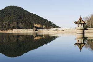An ancient bridge reflected in the waters of a reservoir at Lushan mountain