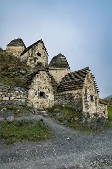 Cemetery Prints: Ancient burial structures stand on a hillside in Dargavs