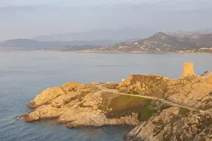 Ile Rousse Prints: The ancient Genoese tower overlooking the blue sea surrounding the village of Ile Rousse