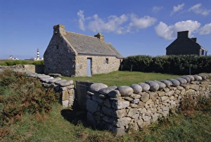 Simple Prints: Ancient house with Creac h lighthouse behind on Ouessant Island, Brittany