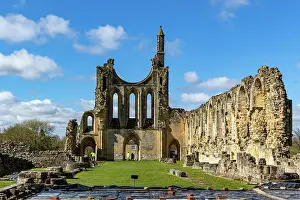 Ancient Ruins Prints: Ancient ruins of a Gothic abbey under blue sky with clouds at Byland Abbey
