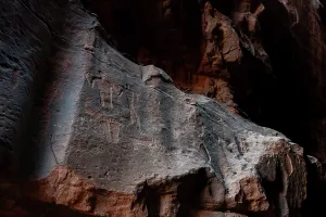 Storytelling Prints: Ancient stone-age petroglyphs carved into rock formations in Khazali Canyon of Wadi Rum desert in Jordan