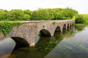 Waterway Prints: Eight Arch Bridge spans a weir in Bosherston Lily Ponds built in 1797 in Pembrokeshire Wales