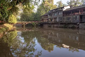 Stillness Prints: Three arched stone bridge with reflections in river at dawn in Shangli Town