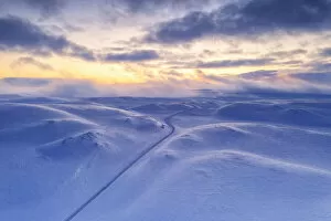 Arctic Gallery: Arctic sunset over Tanafjordveien empty road crossing the snowy mountains after blizzard