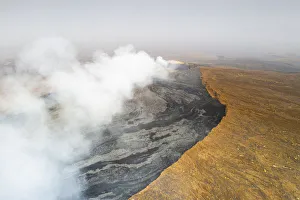 Volcanic Terrain Prints: Arid soil on edge of the smoky Erta Ale volcano from above, Danakil Depression