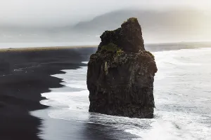 Costal Prints: Detail of Arnardrangur rock in the middle of peninsula near Reynisfjara Beach view point Dyrholaey in overcast weather