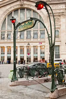 Art Nouveau Prints: The art nouveau entrance to Gare du Nord metro station with the main railway station behind