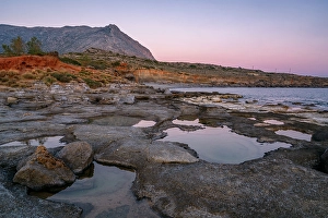 Holes Prints: Aspes beach, natural holes in the rocks full of water at sunset