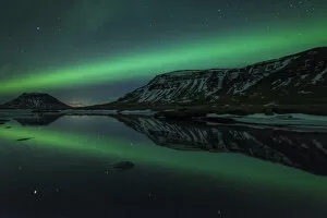 Editor's Picks: Aurora borealis (Northern Lights) reflected in partially frozen lake, North Snaefellsnes