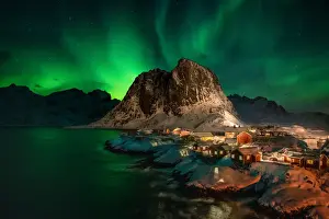 Aurora Borealis (Northern Lights) above Rorbuer fishermens huts, Hamnoy, Moskenesoya