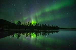 Aurora Borealis and stars over lake at night, Muonio, Lapland, Finland, Scandinavia