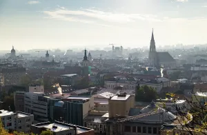 Panoramas Prints: Autumn morning view over the rooftops of Cluj-Napoca with soft sunlight and distant landmarks
