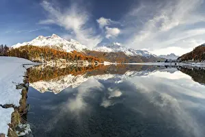Engadine Prints: Autumn woods and snowcapped mountains mirrored in the clear water of Champfer lake