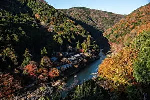 Beautiful Scenery Prints: Autumnal forests with deep blue Katsura Riverwith temple roofs on the river bank in Arashiyama of Kyoto