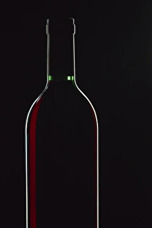Backlit shot of a bottle of red wine