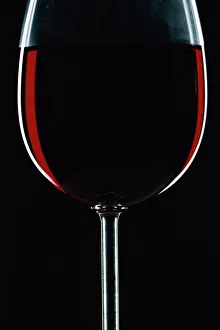 Glass Prints: Backlit shot of a glass of red wine