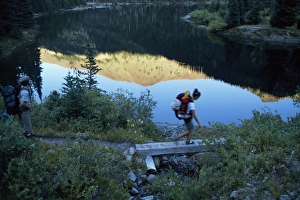 Friend Prints: Backpacker crossing bridge