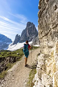 40 To 45 Prints: Backpacker woman with hiking poles enjoying the view to Croda Dei Toni from path