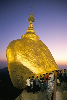 Balanced rock covered in gold leaf, major Buddhist stupa and pilgrim site