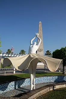 Footpath Prints: Ballerina statue in Ataturk Square displays graceful pose under blue sky in Fethiye