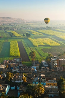 Hot Air Balloon Prints: Ballooning over village near the Valley of the Kings, Thebes, Upper Egypt