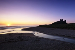 Bamburgh Castle at sunrise, Bamburgh, Northumberland, England, United Kingdom, Europe