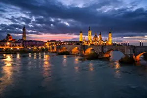 Aragon Prints: Basilica del Pilar Cathedral and Salvador Cathedral with stone bridge crossing Ebro River at night