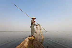 Fishing Net Prints: A basket fisherman after having trapped the fish in the basket will use the long