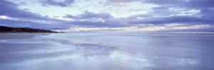 Low Tide Prints: Beach at Alnmouth at dusk with dramatic clouds reflecting in wet sand at low tide