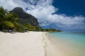 Five Star Hotel Prints: Beach of the Beachcomber Le Paradis Hotel with Mont Brabant in the background