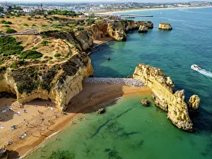 Relaxing Prints: Beach cliffs at sunset with water and sand in Algarve during the evening