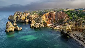 Daylight Prints: Beach cliffs surround the ocean with rocky formations at sunset in Algarve