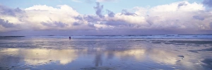 North Umberland Prints: Beach at Embleton Bay with lone walker, dramatic clouds and reflections in wet sand