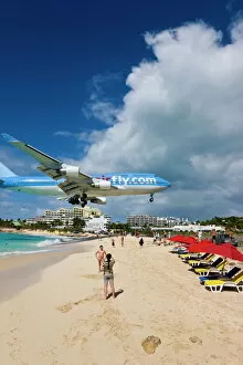 Beach at Maho Bay and low flying aircraft approaching the runway of Princess Juliana International airport, St