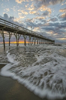 Beach, ocean, waves and pier at sunrise, Sunset Beach, North Carolina, United States of America