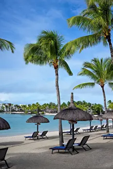 Chairs Prints: Beach with sun beds and umbrellas in Le Touessrok resort