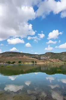 Cappadocia Prints: Beautiful landscape at Akkoy dam lake in Cappadocia with clear water reflection and blue sky full of clouds