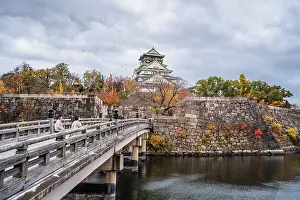 Historical Site Prints: Beautiful Osaka Castle moat in autumn (fall) with bridge leading over the waters towards the Samurai Castle