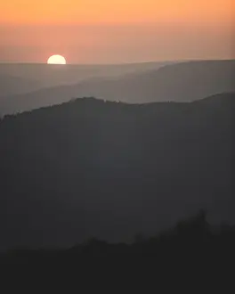 Focus On Background Prints: A beautiful sunset with the sun just dipping behind the hills in the Peak District