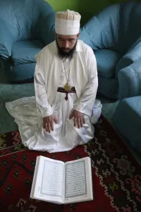 Quran Prints: Bektachi dervish reading Koran, Tirana, Albania, Europe