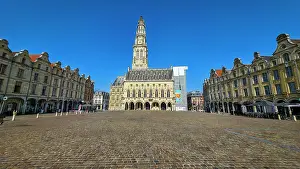 Events Prints: Belfries of Arras stands tall in the city square under a clear blue sky in Arras, France