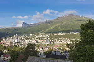 Traditionally Norwegian Prints: Bell tower and houses of the city surrounded by rocky peaks and green hills, Narvik