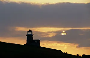 Light House Prints: Belle Tout lighthouse on cliffs at sunset