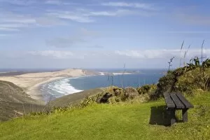 Bench by Cape Reinga Coastal Walkway on cliff top with view to Te Werahi Strand beach