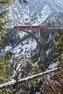 Graubunden Prints: The Bernina Express crossing the Wiesen Viaduct in the Swiss Canton of Graubunden