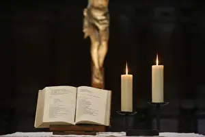 Crucifix Prints: Bible and altar candles, Vienne, Isere, France, Europe