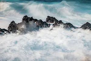 Foam Prints: Big waves crash against dark rocks in Porto Moniz, Madeira, creating foam and splashes